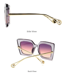 Detail of square cat-eye sunglasses featuring purple gradient lenses and pearl temples