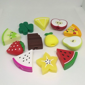 Silicone cable protectors in strawberry and pineapple fruit shapes arranged in a circle