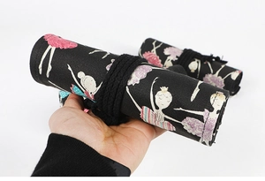 Detail of rolled black canvas pencil wrap with ballerina print and fabric texture