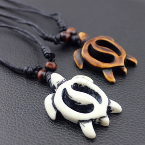 Vintage sea turtle pendants in white and brown bone-style with black woven cord