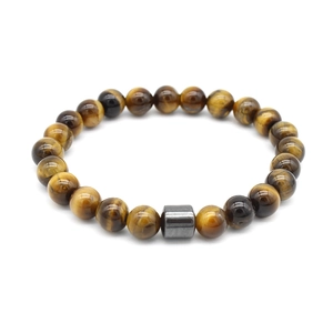 Macro detail of golden brown tiger eye beads with a cylindrical grey metal bead