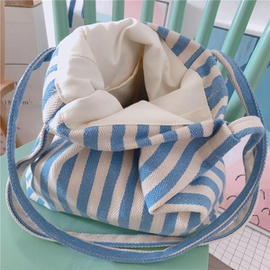 Detailed interior of a thick blue and white striped canvas tote bag with off-white lining