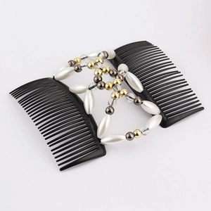 Detail of double-row hair comb with white faux pearls and golden beads on black base