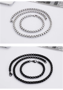 Detailed view of silver and black stainless steel box chain necklaces and bracelets sets