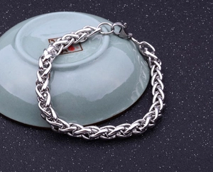 Macro shot of silver woven keel link bracelet with polished stainless steel finish