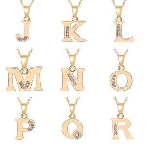 Detail view of gold letter pendants J to R with sparkling zircon crystals on metal chains