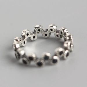 S925 sterling silver wave ring with black zircon stones shown from a macro interior angle