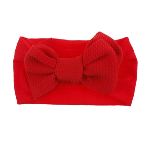 Soft nylon infant headband with large red waffle texture bow for baby girls