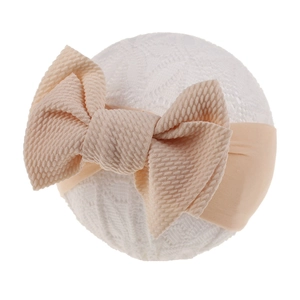 Detail of soft waffle knit bow on stretchy nylon headband for infants and newborns