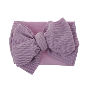 Soft dusty purple baby headband featuring a large waffle-textured fabric bow detail