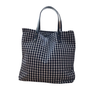 Minimalist black and white plaid cotton tote bag with durable dark leather handles