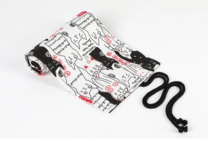 Close-up of canvas pencil roll featuring cute black and white cartoon cat patterns