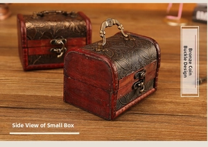 Detail of vintage wooden gift boxes featuring antique metal floral relief and bronze clasps