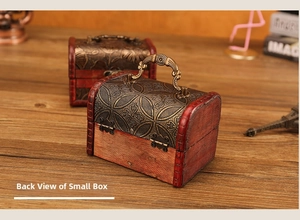 Rear view of vintage wooden jewelry box with antique metal handle and floral embossing