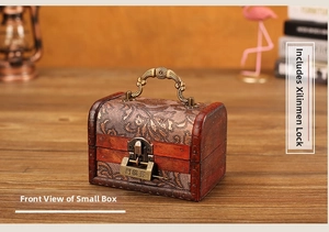 Macro detail of vintage wooden jewelry box with floral fabric lid and antique metal lock
