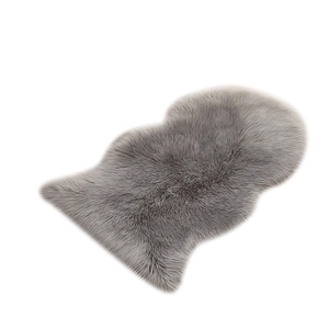 Irregular grey faux sheepskin rug with soft plush texture for living room decor