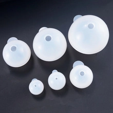 Detail view of six translucent spherical silicone molds in various sizes for DIY resin chess