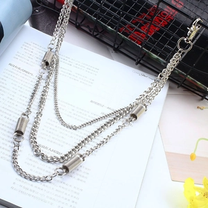 Detail of silver double-layered punk metal chains with spring charms on a magazine