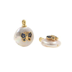 Detailed view of pearl button pendants with gold butterflies and blue stones for DIY jewelry