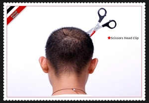 Detail of Halloween prank scissors headband with realistic fake blood on a white background