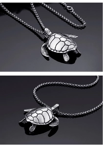 Macro view of silver turtle pendant necklace in polished stainless steel with box chain