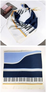 Detailed view of piano key print satin scarf with navy and orange geometric patterns