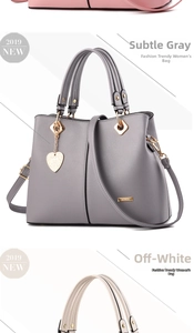 Detailed view of fashion handbags in gray and white with heart-shaped metal charms