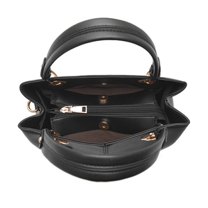 Top view of black PU leather handbag with gold hardware and multiple inner compartments