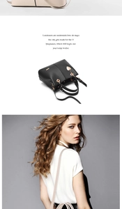Detail of fashion top-handle bag with gold hardware and heart charm in black and beige