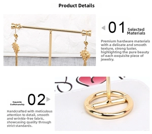 Detail of gold metal T-bar earring stand with round base and hand-crafted finish