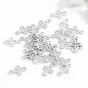 Bulk silver hollow cross pendants for DIY jewelry making displayed on a white surface