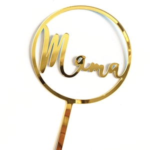 Close-up of golden mirror acrylic Mama cake topper with circular frame detail