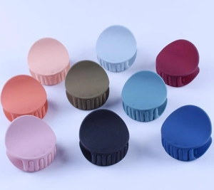 Detailed overhead view of 12cm matte bow hair claws in nine various trendy colors