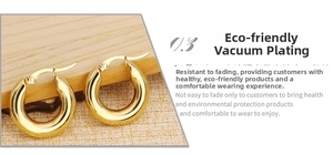 Detail of chunky gold hoop earrings with a thick polished finish on a wooden display
