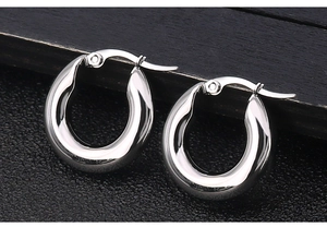 Detailed macro view of silver stainless steel thick hoop earrings with polished finish