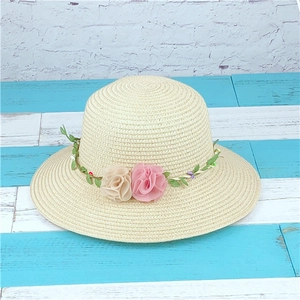 Beige woven straw sun hat for women featuring a delicate green vine and floral headband