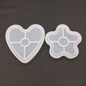 Macro detail of heart and flower-shaped silicone molds for DIY resin coasters