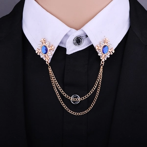 Detail of vintage gold collar clips with blue stones, rhinestones and double chains
