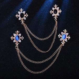 Vintage gold collar chain with rhinestone cross stars and blue gems on navy background