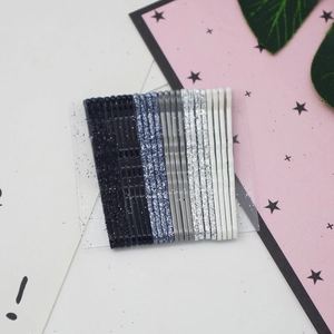 Set of 12 glittery metal wave bobby pins arranged neatly on a stylish card display