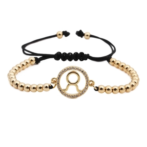 Detail of adjustable Taurus constellation bracelet with gold beads and cubic zirconia