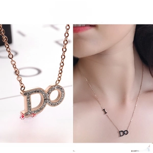 Detail of rose gold cylinder pendant with sparkling rhinestones on woman neck