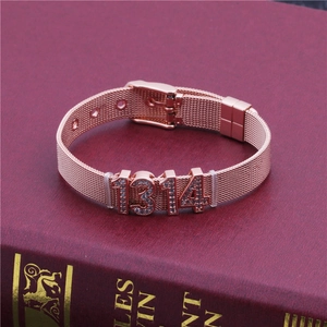 Detail showing rose gold mesh bracelet with 1314 rhinestone numbers on a book