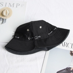 Close-up of black bucket hat with adjustable sport cord and metal ventilation eyelets