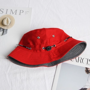 Detail of red bucket hat featuring SPORT drawstring and silver ventilation eyelets