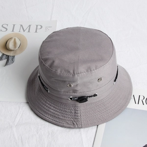 Close-up of grey bucket hat with adjustable drawcord, ventilation eyelets and brim stitching