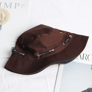Detailed view of dark brown canvas bucket hat featuring sport lettered drawstring cord