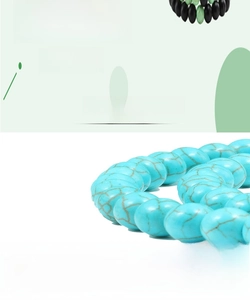 Detail of blue turquoise beads with brown marble texture on a beaded bracelet