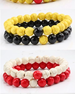 Detail of colorful matte bead bracelets with realistic stone textures and elastic band