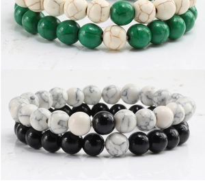 Close-up of beaded bracelets set with turquoise and matte black stone beads